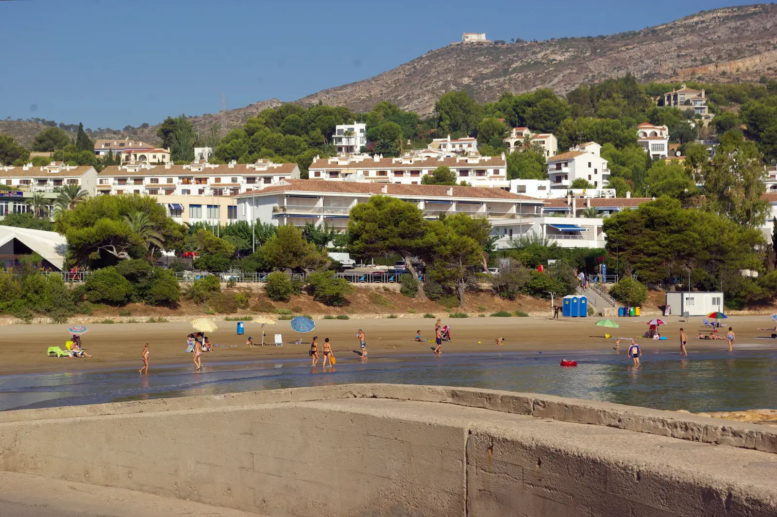 Playa de Las Fuentes en Alcossebre en verano, con bañistas y la sierra al fondo